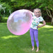 Girl Standing with air wubble bubble Ball in garden