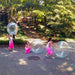 Three Girl playing with air wubble bubble Ball in garden